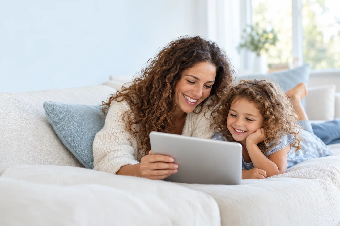 A mother and her daughter smiling while using Weebou on a tablet